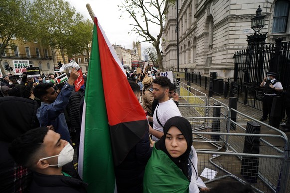 People gather outside Downing Street to protest against Israeli attacks on Palestinians in Gaza, in London, Saturday, May 15, 2021. (AP Photo/Alberto Pezzali)