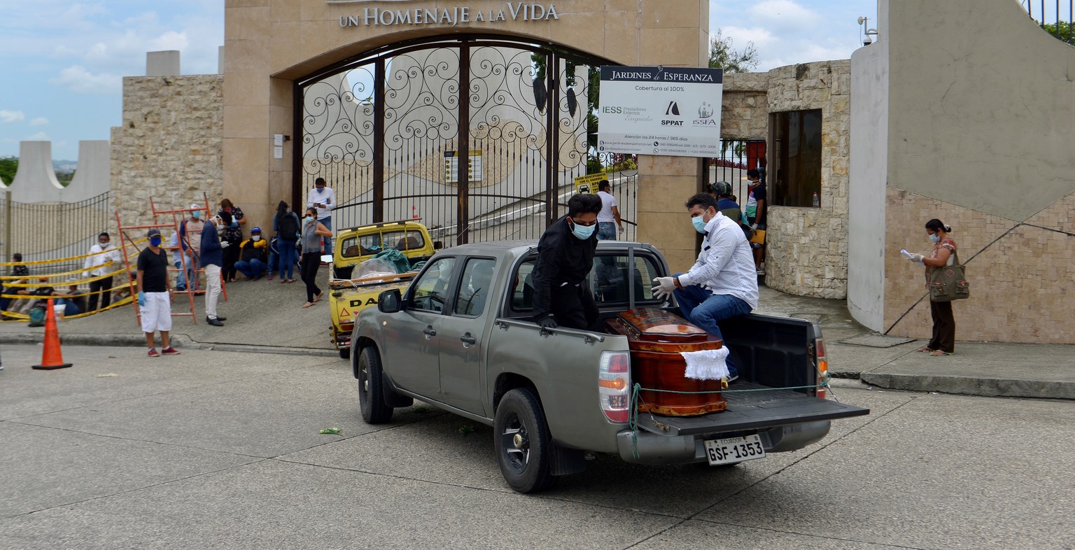 epa08337705 People with facial masks transport the coffin of a deceased to a cemetery in Guayaquil, Ecuador, 01 April 2020. The sudden spread of the coronavirus in the Guayaquil area, has created a si ...