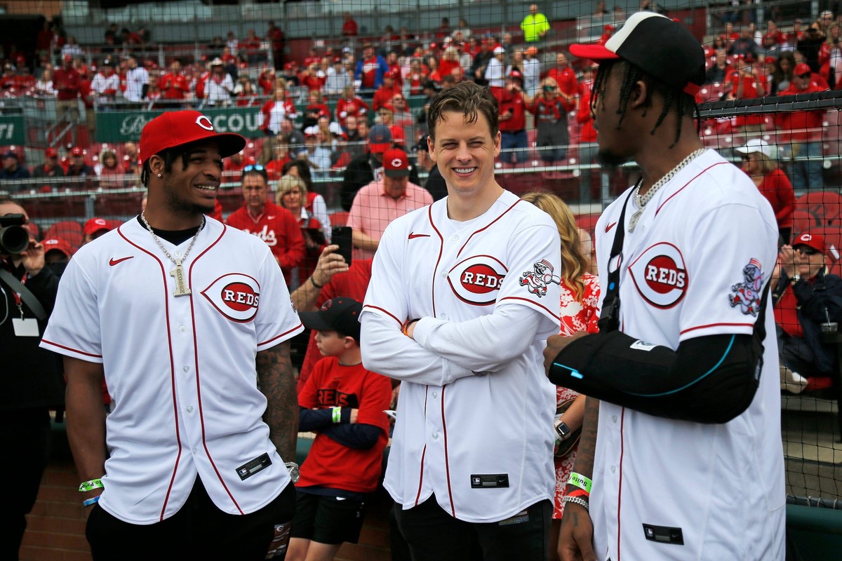 Syndication: The Enquirer Cincinnati Bengals quarterback Joe Burrow center talks with wide receivers Ja Marr Chase left Tee Higgins right before the Reds home opening game between the Cincinnati Reds  ...