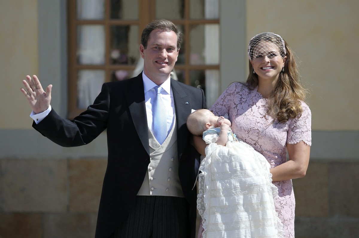 epa04244902 (L-R) Mr Christopher O'Neill, Princess Leonore and Princess Madeleine of Sweden wave to the crowd outside the church after the christening ceremony in the Drottningholm Palace church  ...