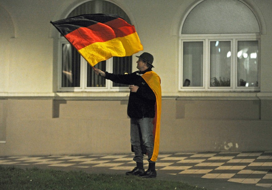 «Von Muslimen bedroht» – ein Mann schwenkt anlässlich einer Pegida-Demonstration in Dresden die Deutschland-Fahne.