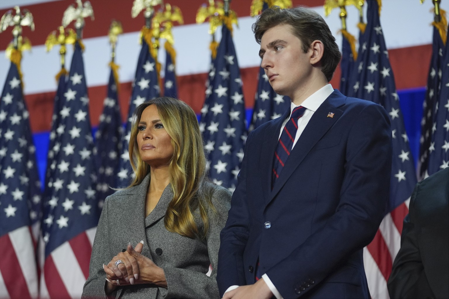 Former first lady Melania Trump and Barron Trump listen as Republican presidential nominee former President Donald Trump speaks at an election night watch party at the Palm Beach Convention Center, We ...