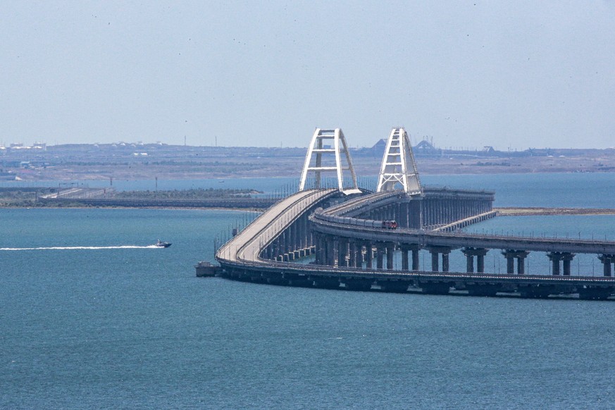 A freight train runs on rails of a railway link of the Crimean Bridge connecting Russian mainland and Crimean peninsula over the Kerch Strait not far from Kerch, Crimea, on Monday, July 17, 2023. An a ...