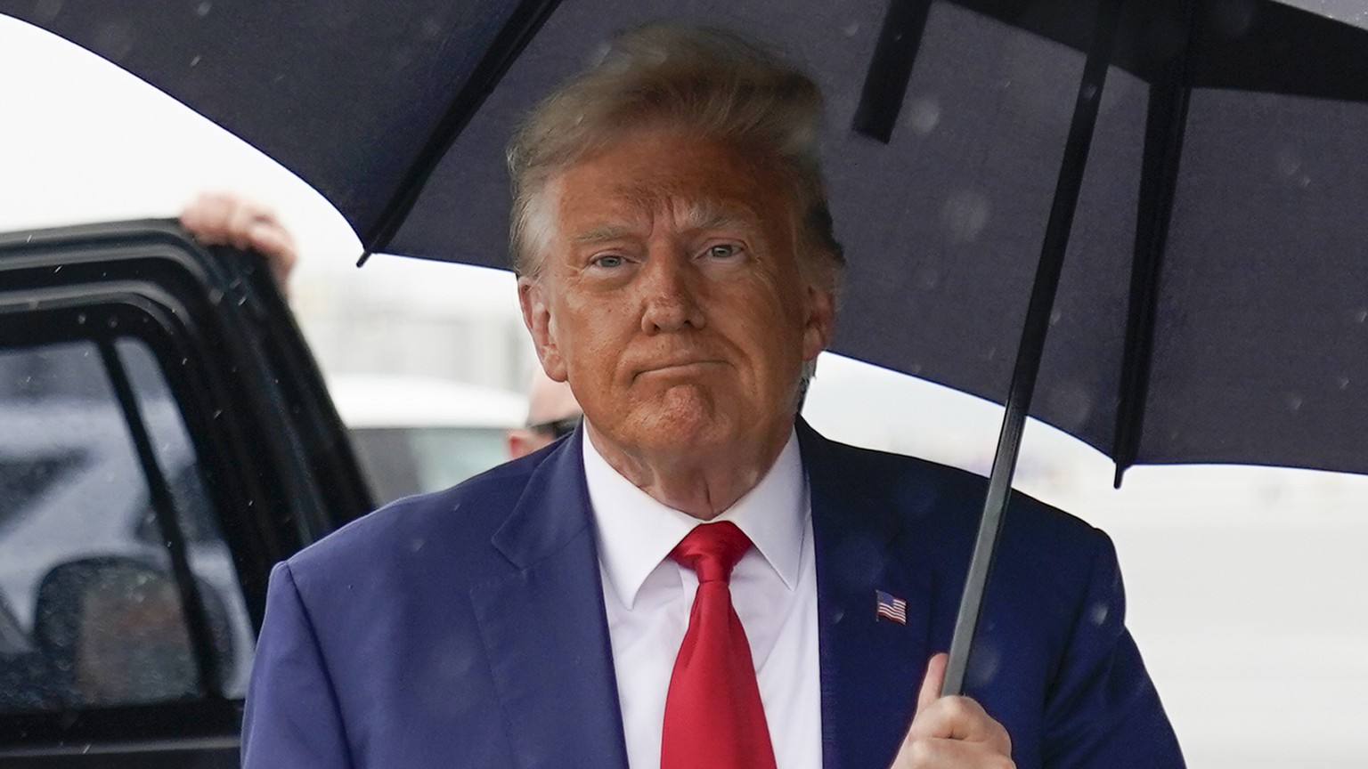 Former President Donald Trump walks to speak with reporters before he boarding his plane at Ronald Reagan Washington National Airport, Thursday, Aug. 3, 2023, in Arlington, Va., after facing a judge o ...