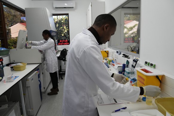 Lab technician Xolile Mhlanga works with vials of lenacapavir at the Desmond Tutu Health Foundation&#039;s Masiphumelele Research Site, in Cape Town, South Africa, Tuesday, July 23, 2024. Twice-yearly ...