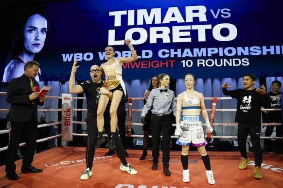 Gabriela Timar of Switzerland, left, celebrates after winning the WBO world championship atomweight fight against Marina Loreto of Japan, at the Boxing Day meeting in Bern, Switzerland, Friday, Decemb ...