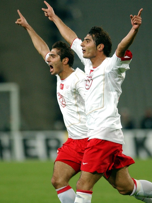 Turkey's Halil Altintop, right, celebrates with his brother Hamit Altintop after he scored his team's first goal against Germany at the Ataturk Olympic Stadium in Istanbul, Turkey, Saturday, Oct. 8, 2 ...