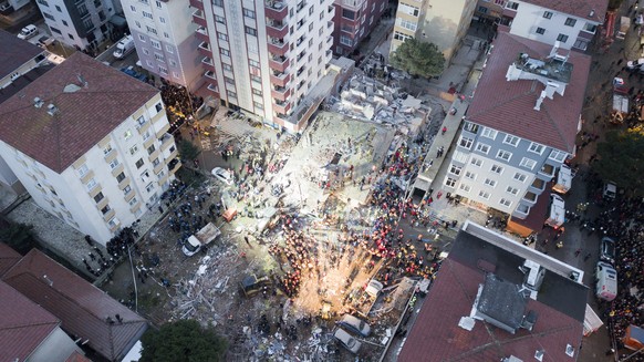 epa07348041 An aerial picture taken with drone shows rescuers working at the site of a collapsed building in Kartal district of Istanbul, Turkey, 06 February 2019. According to initial reports, at lea ...