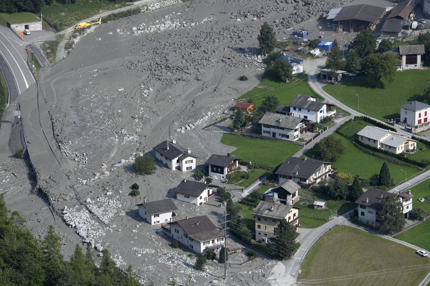 epa06162690 A general aerial view showing as mud rushes towards the village after another eruption, in Bondo, Graubuenden in South Switzerland, 25 August 2017. The village had been hit by a massive la ...