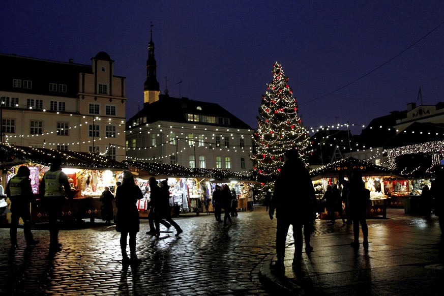 epa08027089 Visitors at the Christmas market in the Town Hall Square, Tallinn, Estonia, 26 November 2019. Reports state that the Christmas tree, which is the most important Christmas tree in Estonia a ...