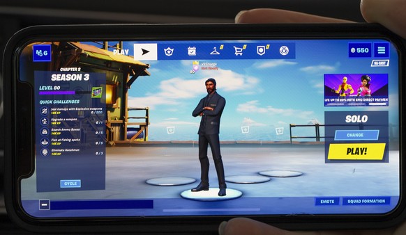 epa08623375 The 'launch screen' of the video game Fortnite, seen on an Apple iPhone X in Billerica, Massachusetts, USA, 24 August 2020. Epic Games Inc., the maker of the popular game Fortnite, is in a ...