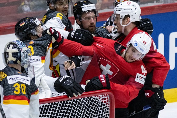 Switzerland&#039;s Pius Suter, right, in action against Germany&#039;s Leon Gawanke during the Ice Hockey World Championship group A preliminary round match between Switzerland and Germany in Helsinki ...