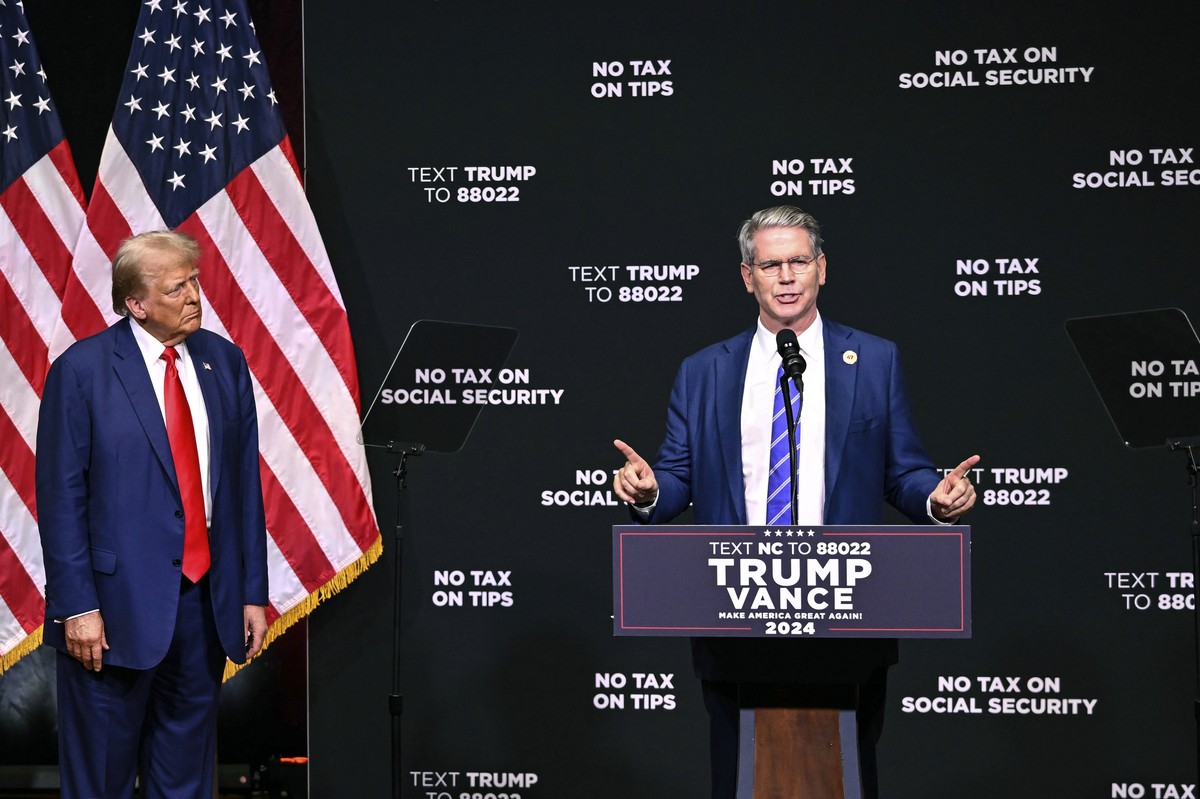 Republican presidential nominee former President Donald Trump, left, listens as investor Scott Bessent speaks on the economy in Asheville, N.C., Wednesday, Aug. 14, 2024. (AP Photo/Matt Kelley)