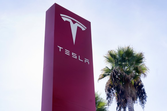 FILE - A Tesla sign is seen at Tesla in Buena Park, Calif. on Sunday Dec. 3, 2023. Tesla is recalling more than 3,000 of its 2024 Cybertrucks because of the possibility that a pedal can get stuck and  ...