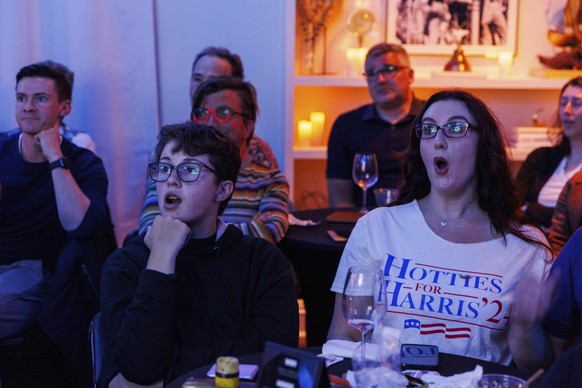 Simon Sutton, 14, and his stepmom Summer Stagg react during a presidential debate between Democratic presidential nominee Vice President Kamala Harris and Republican presidential nominee former Presid ...