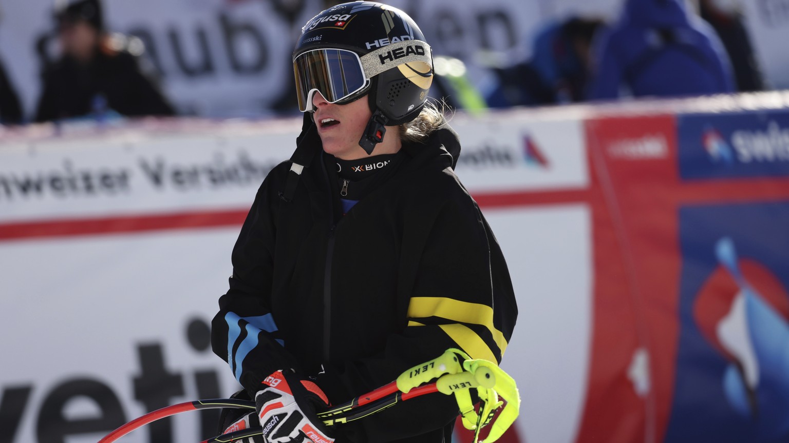 Switzerland&#039;s Lara Gut-Behrami grimaces in the finish area after crashing during an alpine ski, women&#039;s World Cup super-G in St. Moritz, Switzerland, Sunday, Dec. 12, 2021. (AP Photo/Marco T ...