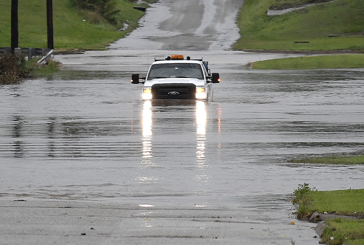 A pickup truck drives on a flooded street in Enid, Okla., Monday, May 20, 2019. An intense storm system that weather forecasters labeled "particularly dangerous" swept through the Southern P ...