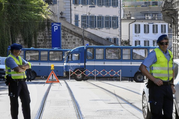 Policemen and police vehicles seen on the occasion of the annual technoparade &quot;Street Parade&quot; in the city center of Zurich, Switzerland, Saturday, 13 August, 2016. Hundreds of thousands of r ...