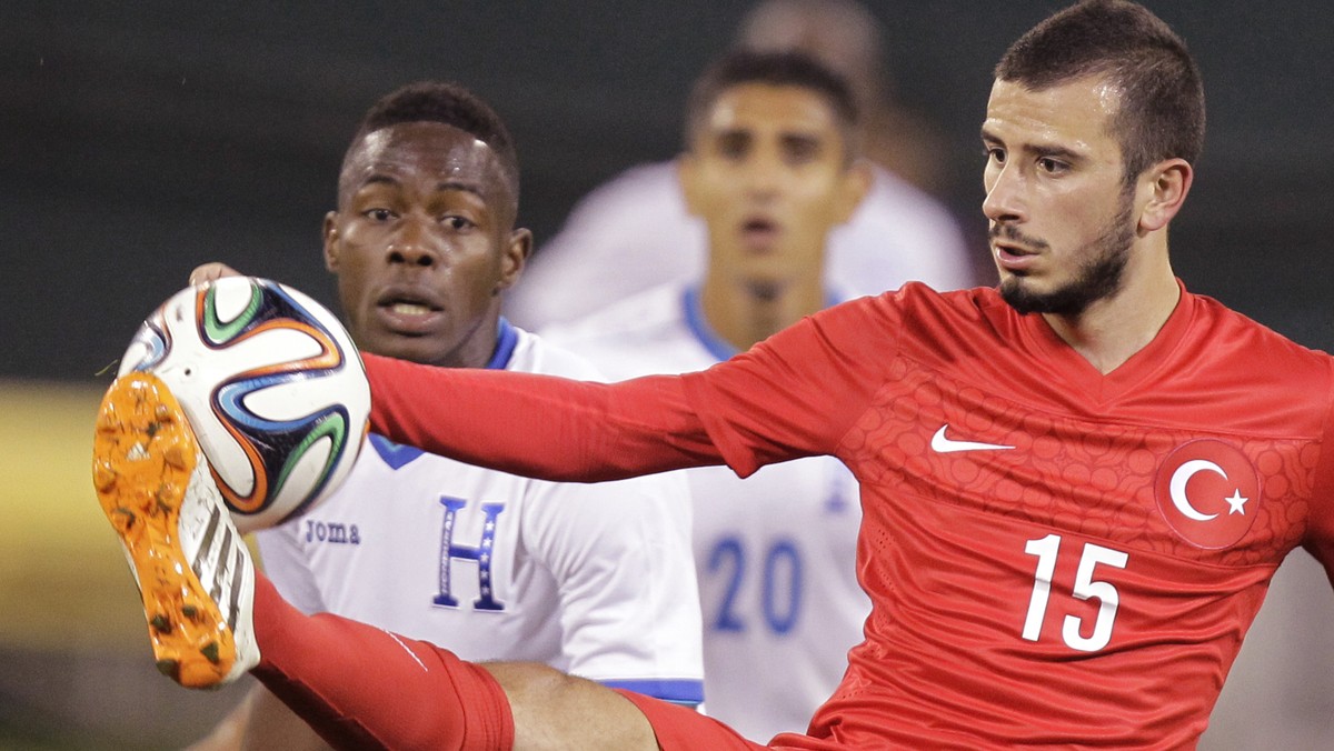 Turkey's Oguzhan Ozyakup (15) kicks the ball as Honduras’ Maynor Figueroa, left, defends during the second half of an exhibition soccer game, Thursday, May 29, 2014, in Washington. Turkey won 2-0 ...