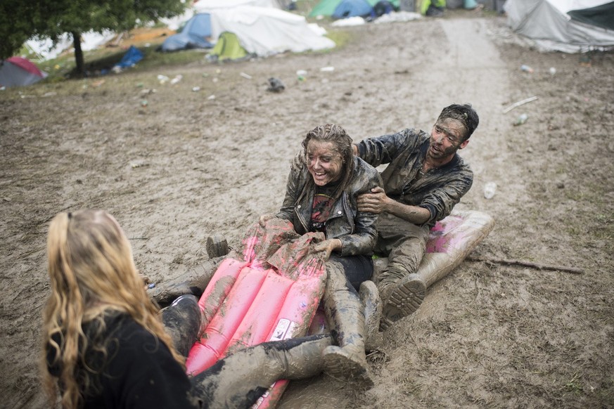 Visitors play in the mud during the music festival Openair St. Gallen, on Sunday, July 2, 2017. The festival will take place until Sunday, July 2, 2017. (KEYSTONE/Ennio Leanza)