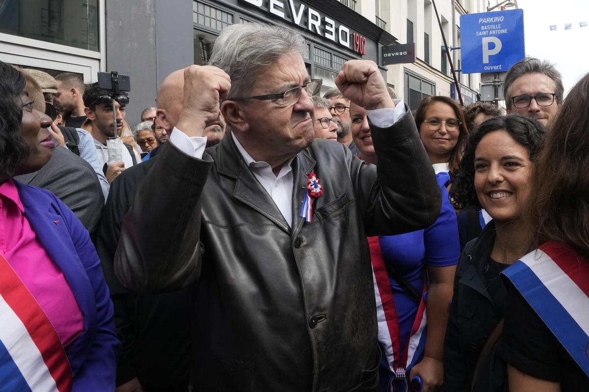 France Unbowed leader Jean-Luc Melenchon, center, who criticized as a power grab the president's appointment of a conservative new prime minister, Michel Barnier, gestures as he participates in a ...
