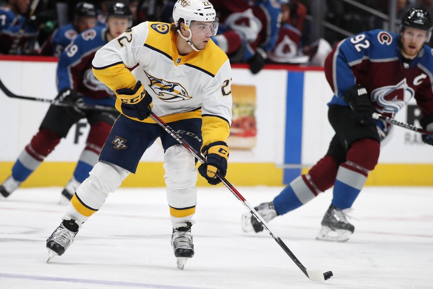 Nashville Predators left wing Kevin Fiala, front, passes the puck as Colorado Avalanche left wing Gabriel Landeskog defends during the first period of an NHL hockey game Friday, March 16, 2018, in Den ...