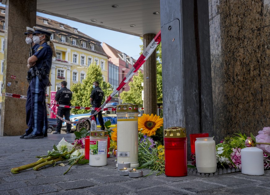 Flowers and candles were laid at the crime scene in central Wuerzburg, Germany, Saturday, June 26, 2021. German police say several people have been killed and others injured in a knife attack in the s ...