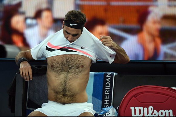 epa06469869 Roger Federer of Switzerland changes his shirt bretween games during his men&#039;s singles quarter final match against Tomas Berdych of Czech Republic at the Australian Open Grand Slam te ...