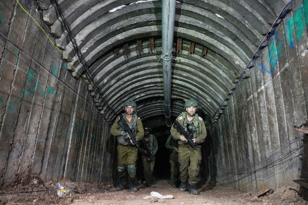 Israeli soldiers are seen in a tunnel that the military says Hamas militants used to attack the Erez crossing in the northern Gaza Strip, Friday, Dec. 15, 2023. The army is battling Palestinian milita ...