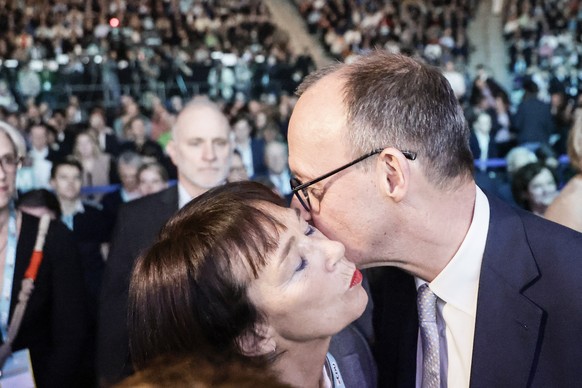 epa11913708 Christian Democratic Union (CDU) party chairman Friedrich Merz (R) kisses his wife Charlotte (L), during election campaign event in Oberhausen, Germany, 21 February 2025. Germany will hold ...