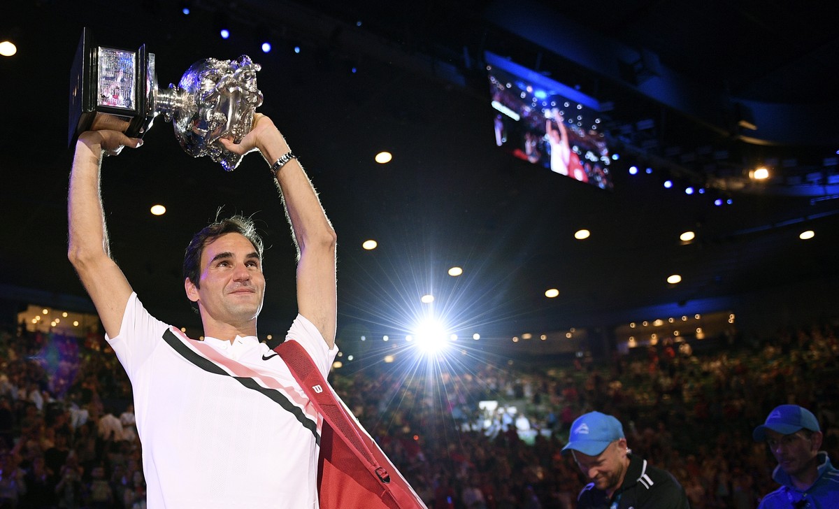 Switzerland's Roger Federer holds his trophy aloft after defeating Croatia's Marin Cilic during the men's singles final at the Australian Open tennis championships in Melbourne, Austral ...