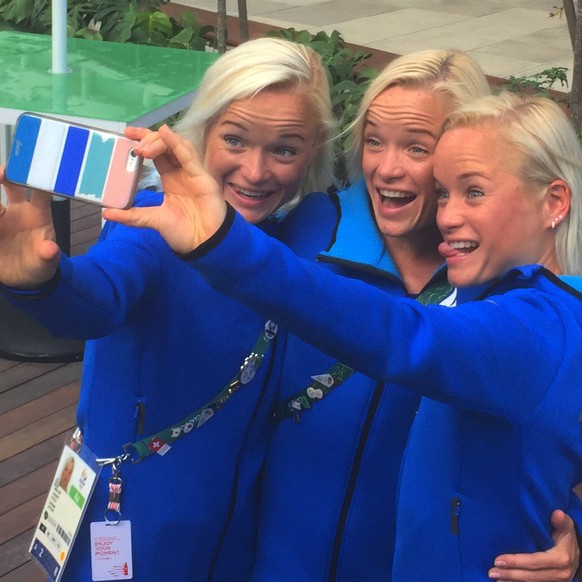 In this Friday, Aug. 12, 2016 photo, Estonian triplets, from left, Leila, Liina and Lily Luik take a selfie outside the Main Press Center at the 2016 Summer Olympics in Rio de Janeiro, Brazil. Olympic ...