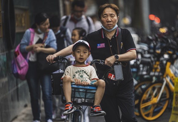 epa09191127 Parents take children home after school in Shanghai, China, 11 May 2021. China&#039;s population on the mainland reached 1,411,78 billion, growing 0.53 percent on average annually in the p ...