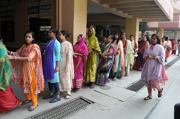 epa11062384 Bangladeshi voters queue to cast their vote at a polling center during the 12th national general election in Dhaka, Bangladesh, 07 January 2024. The last general election in Bangladesh was ...