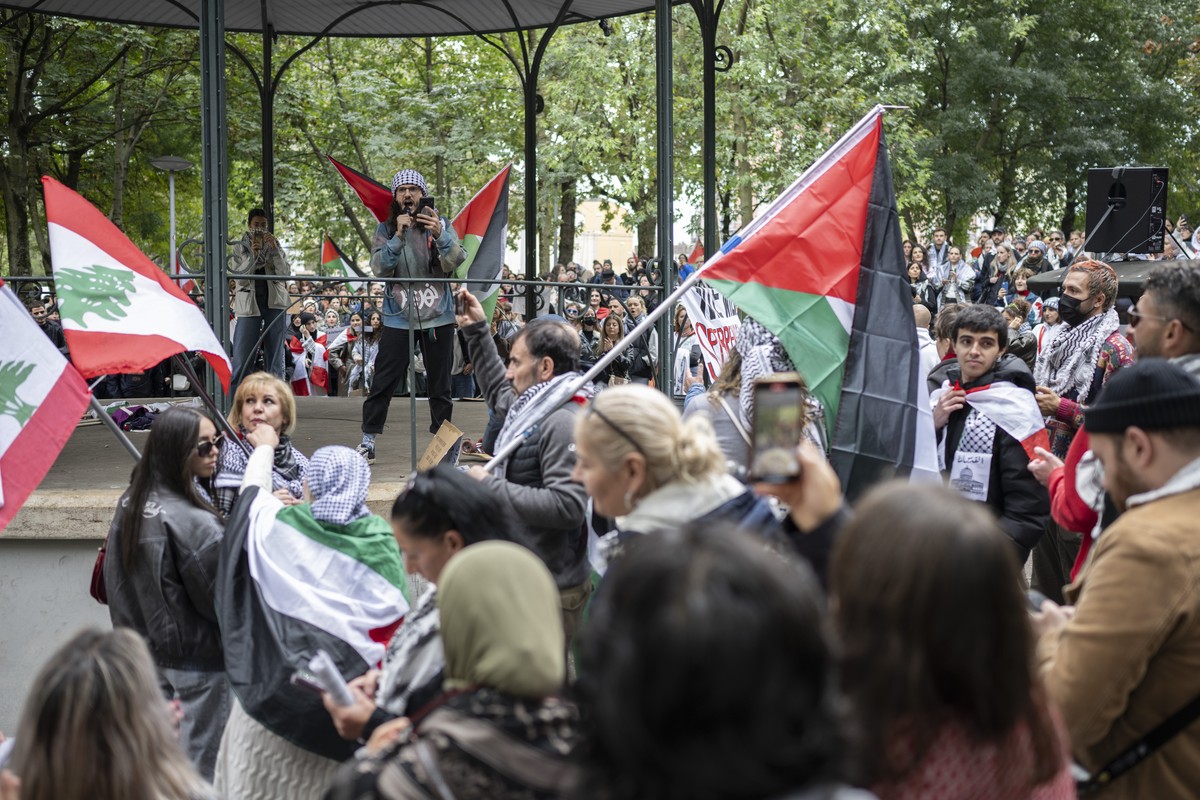 Protesters hold placards and Palestinian flags during a rally in support of the Palestinian people in Basel, Switzerland, 05 October 2024. Upcoming 07 October 2024, marks one year since the Palestinia ...