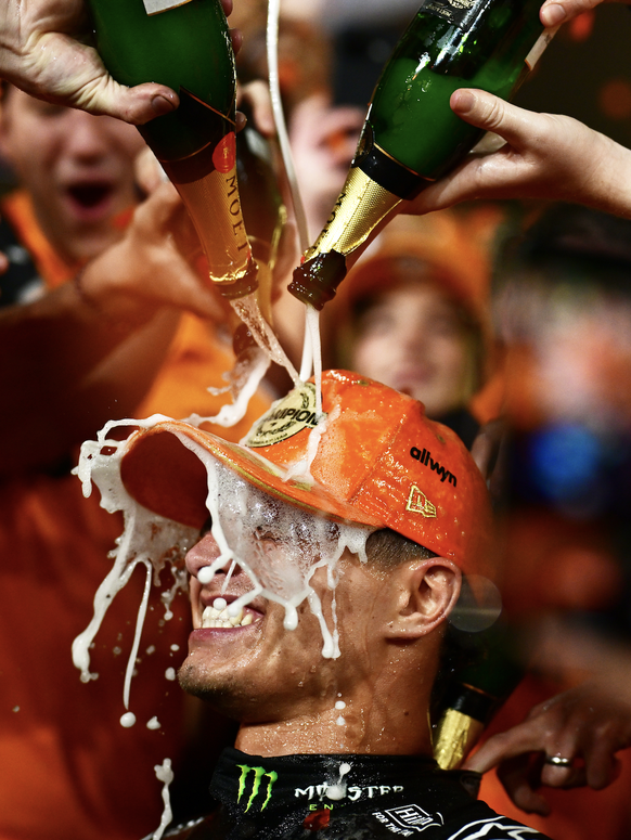 ABU DHABI, UNITED ARAB EMIRATES - DECEMBER 07: 2025 F1 World Drivers Champion Lando Norris of Great Britain and McLaren celebrates with his team during the F1 Grand Prix of Abu Dhabi at Yas Marina Cir ...