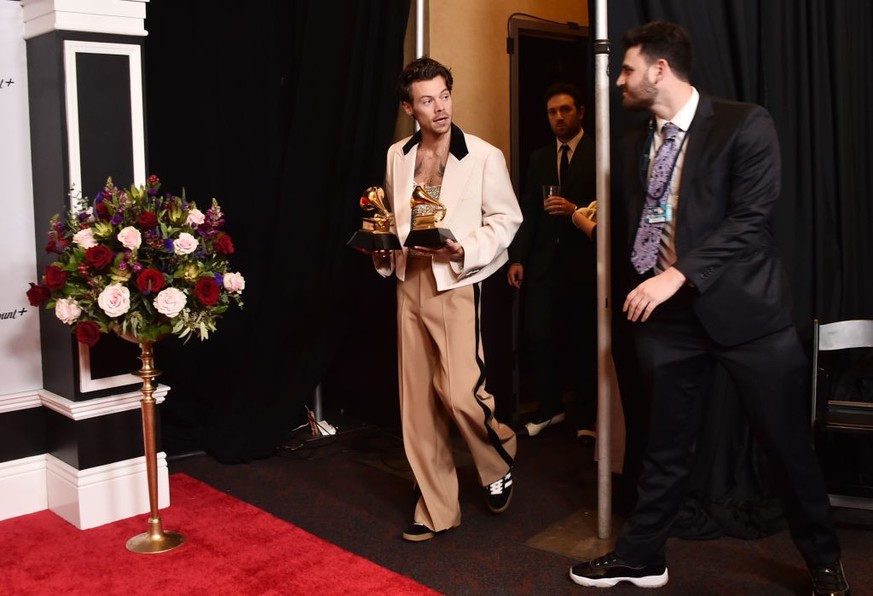 LOS ANGELES, CALIFORNIA - FEBRUARY 05: Harry Styles poses with the Best Pop Vocal Album Award for “Harry’s House” and Album of the Year Award for “Harry’s House” in the press room during the 65th GRAM ...