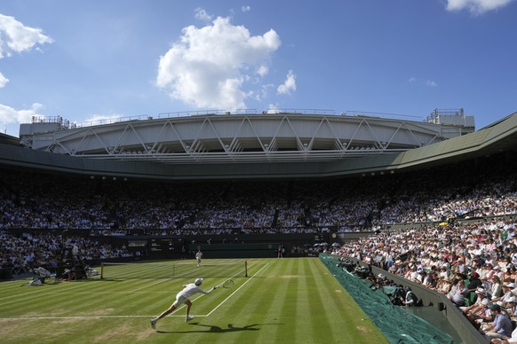 Italy's Jannik Sinner returns to Carlos Alcaraz of Spain in the men's singles final at the Wimbledon Tennis Championships in London, Sunday, July 13, 2025. (AP Photo/Kin Cheung)
Britain Wimb ...