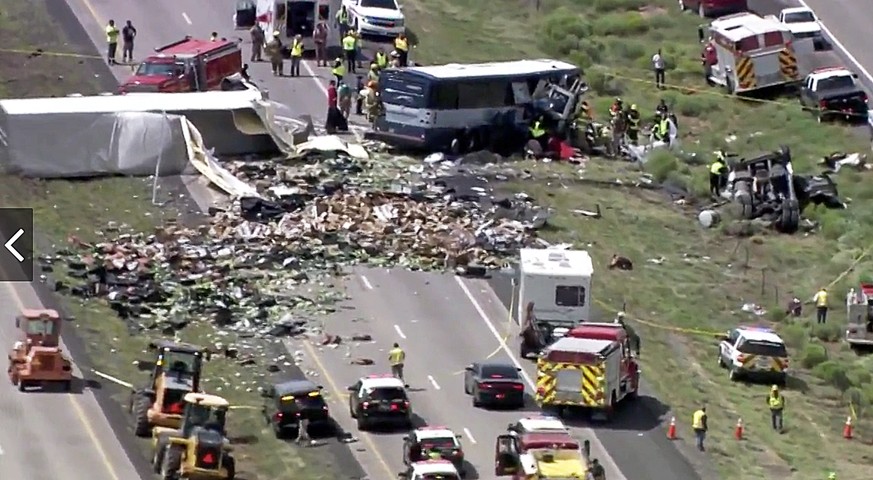 This photo from video provided by KQRENews13 shows first responders working the scene of a deadly collision between a Greyhound passenger bus and a semi-truck on Interstate 40 near the town of Thoreau ...