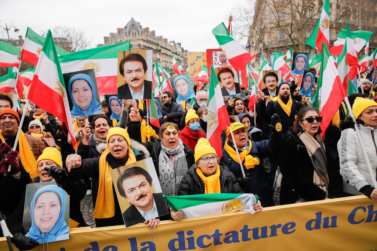 epa10463087 Supporters hold portrait of Masud Rajavi (R), one of the leaders of the People's Mojahedin Organization of Iran, and Maryam Rajavi (L), President of the Iranian National Council of Re ...