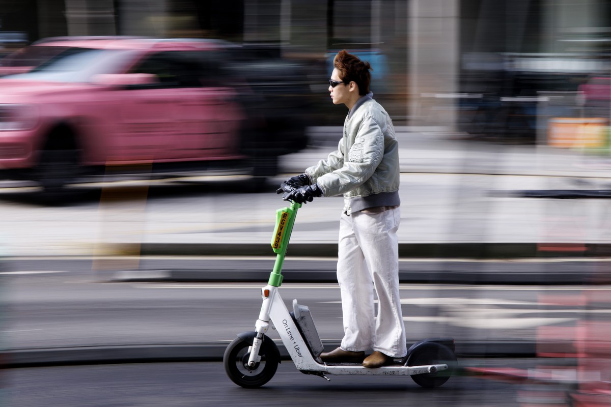 epa11923954 A person rides a Lime rental e-scooter in central London, Britain, 25 February 2025. Westminster council will convert around 200 car parking spaces in central London into parking bays for  ...