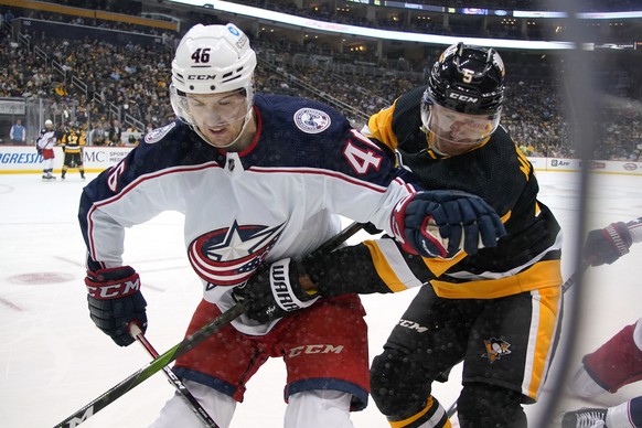 Columbus Blue Jackets&#039; Dean Kukan (46) and Pittsburgh Penguins&#039; Mike Matheson go into the corner after the puck during the second period of an NHL hockey game in Pittsburgh, Tuesday, March 2 ...