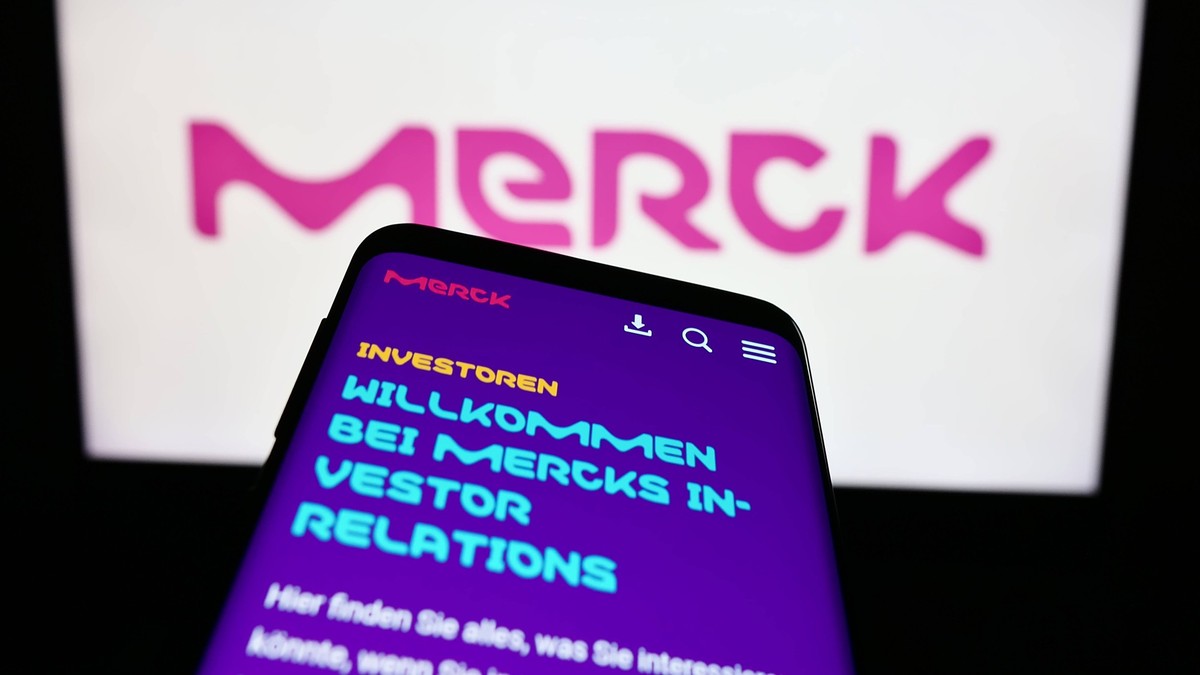 Mobile phone with website of German pharmaceutical company Merck KGaA on screen in front of logo. Stuttgart, Germany - 09-17-2023: Mobile phone with website of German pharmaceutical company Merck KGaA ...
