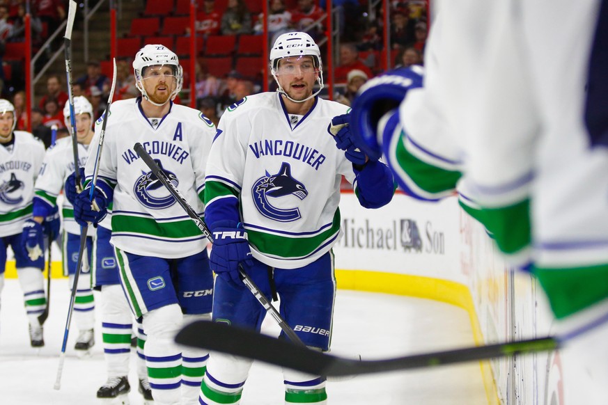 Dec 13, 2016; Raleigh, NC, USA; Vancouver Canucks forward Sven Baertschi (47) is congratulated by teammates after his second period goal against the Carolina Hurricanes at PNC Arena. Mandatory Credit: ...