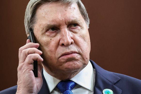 Russian Presidential foreign policy adviser Yuri Ushakov speaks on the phone on the sidelines of an international forum in Ashgabat, Turkmenistan, Friday, Dec. 12, 2025. (Alexander Kazakov/Sputnik, Kr ...