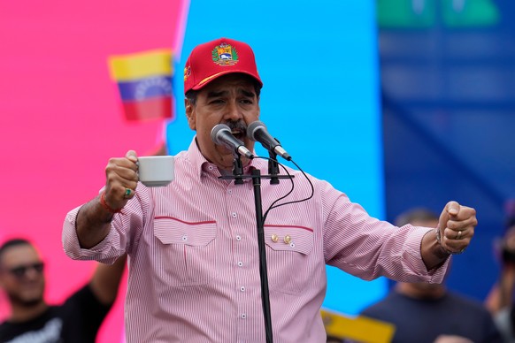 Venezuelan President Nicolas Maduro addresses supporters during a swearing-in event for government-organized neighborhood committees at the presidential palace in Caracas, Venezuela, Monday, Dec. 1, 2 ...