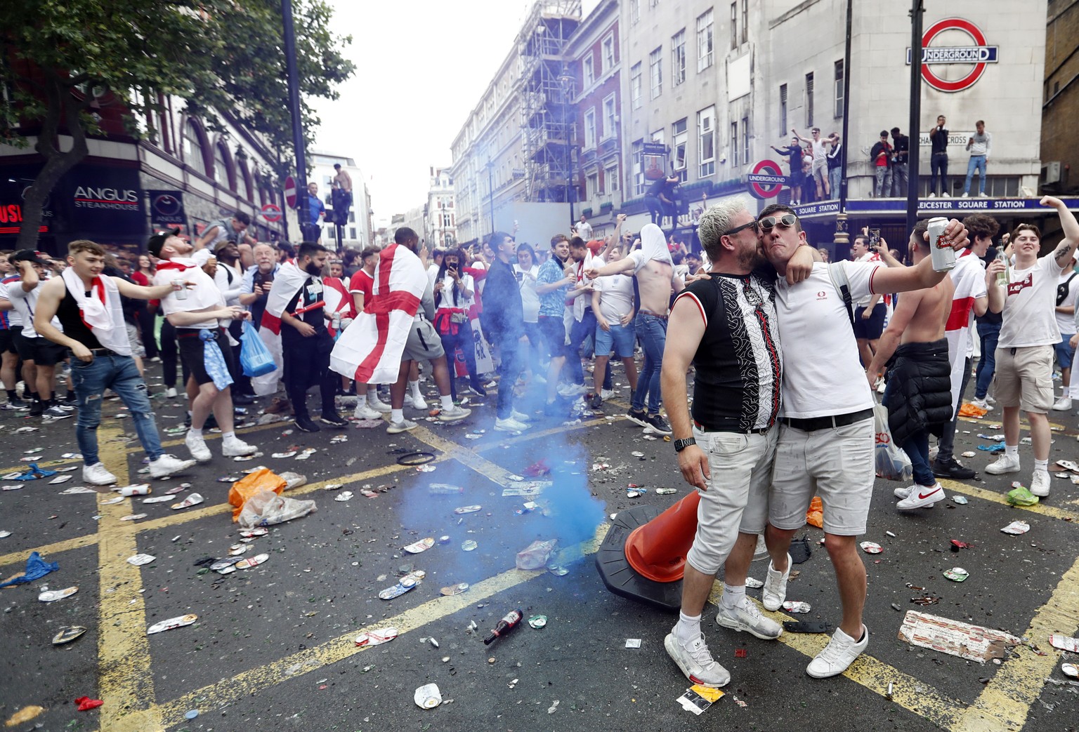 Fans react outside Leicester Square underground station in London, Sunday, July 11, 2021, prior to the Euro 2020 soccer championship final match between England and Italy which will be played at Wembl ...