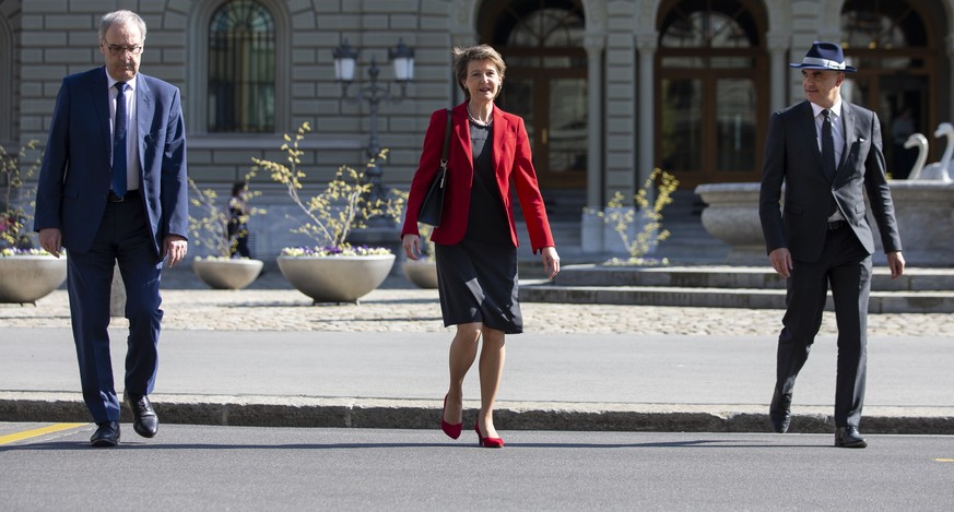 Bundesrat Alain Berset, Bundespraesidentin Simonetta Sommaruga und Bundesrat Guy Parmelin, von rechts, kommen zu einer Medienkonferenz des Bundesrates ueber die Situation des Coronavirus, am Mittwoch, ...