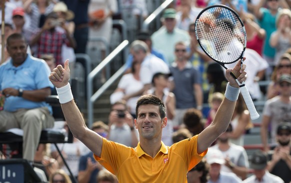 Novak Djokovic, of Serbia, celebrates his victory over Jeremy Chardy, of France, during the semifinals at the Rogers Cup tennis tournament on Saturday, Aug. 15, 2015 in Montreal. Djokovic won 6-4, 6-4 ...