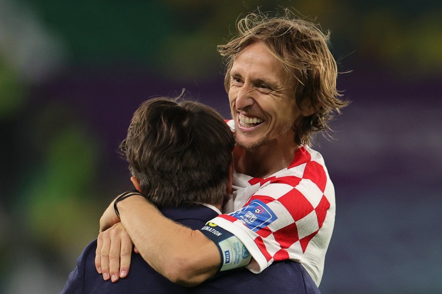 epa10357554 Head coach Zlatko Dalic (L) of Croatia and his player Luka Modric celebrate after winning the FIFA World Cup 2022 quarter final soccer match between Croatia and Brazil at Education City St ...